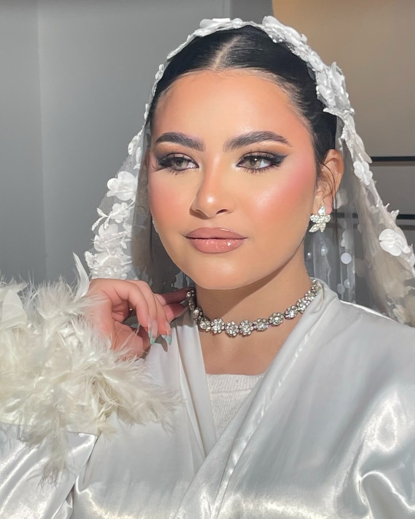 Bride with luminous soft glam wedding makeup and lace veil