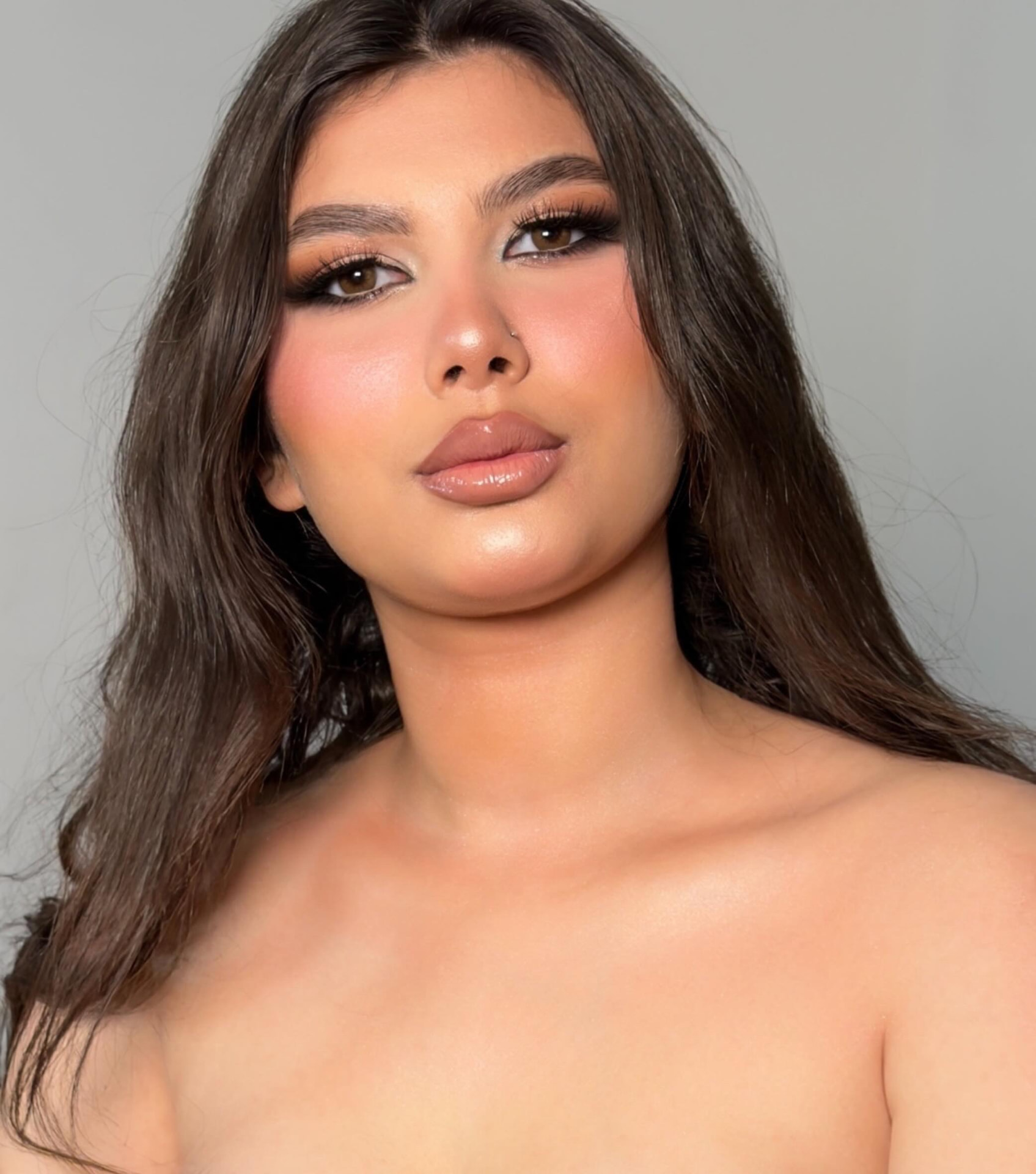 Elegant soirée makeup with bronze tones and styled black hijab