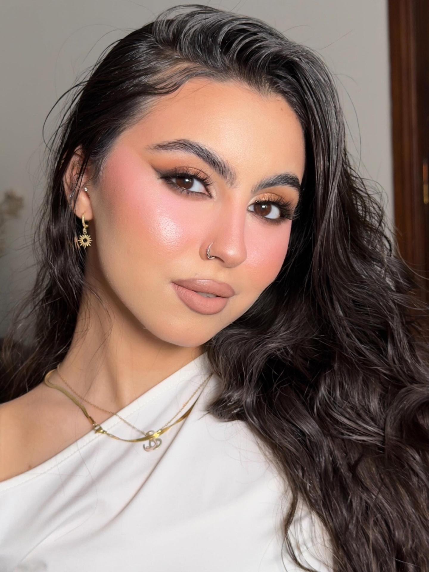 Soft glam makeup with peach blush and radiant skin